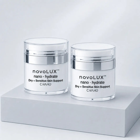 Two clear cosmetic jars with white lids and silver bands, labeled novoLUX nano hydrate, displayed on a light gray pedestal against a soft white background.