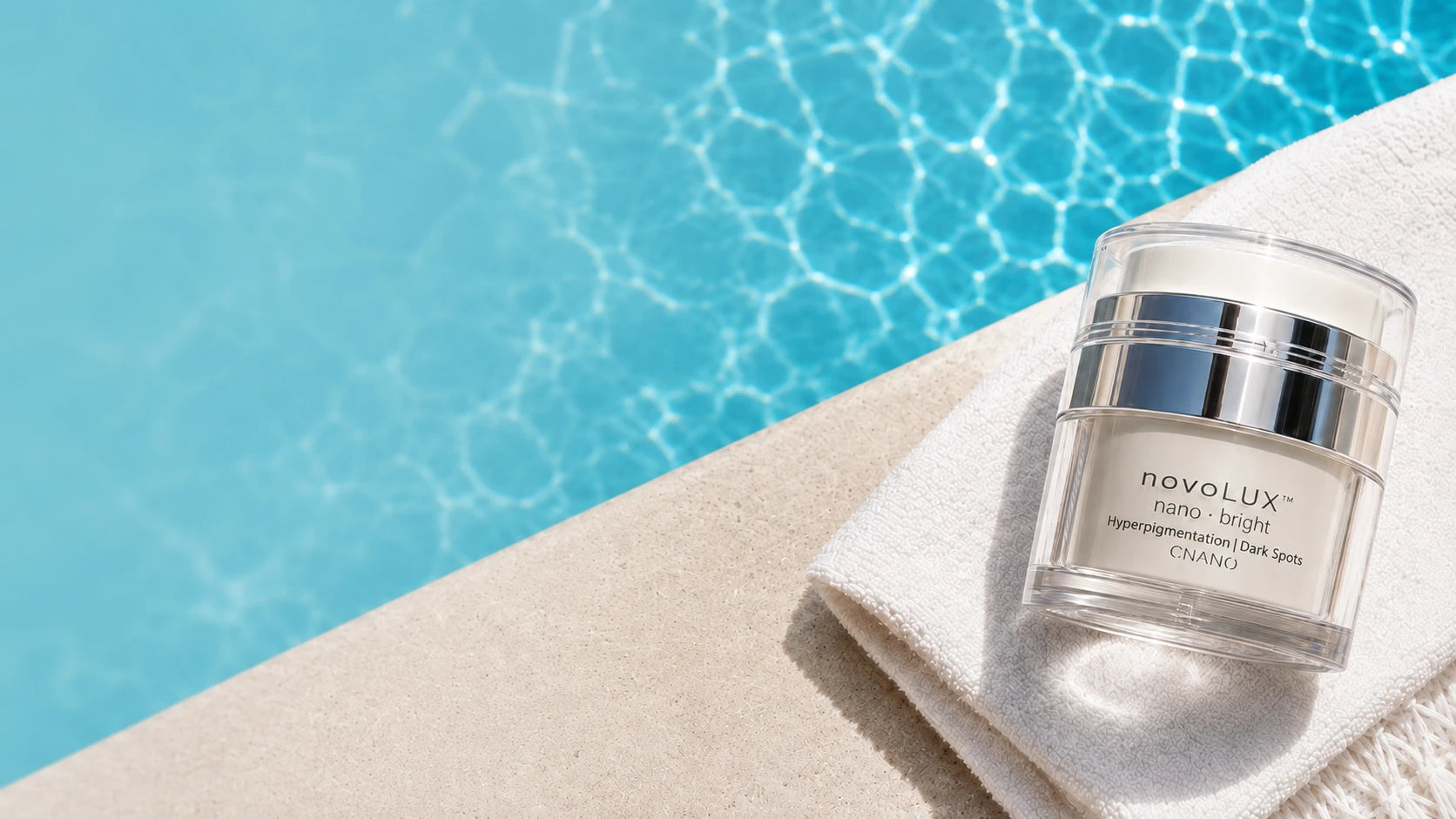 A jar of novoLUX nano bright sits on a folded white towel beside a bright blue swimming pool.