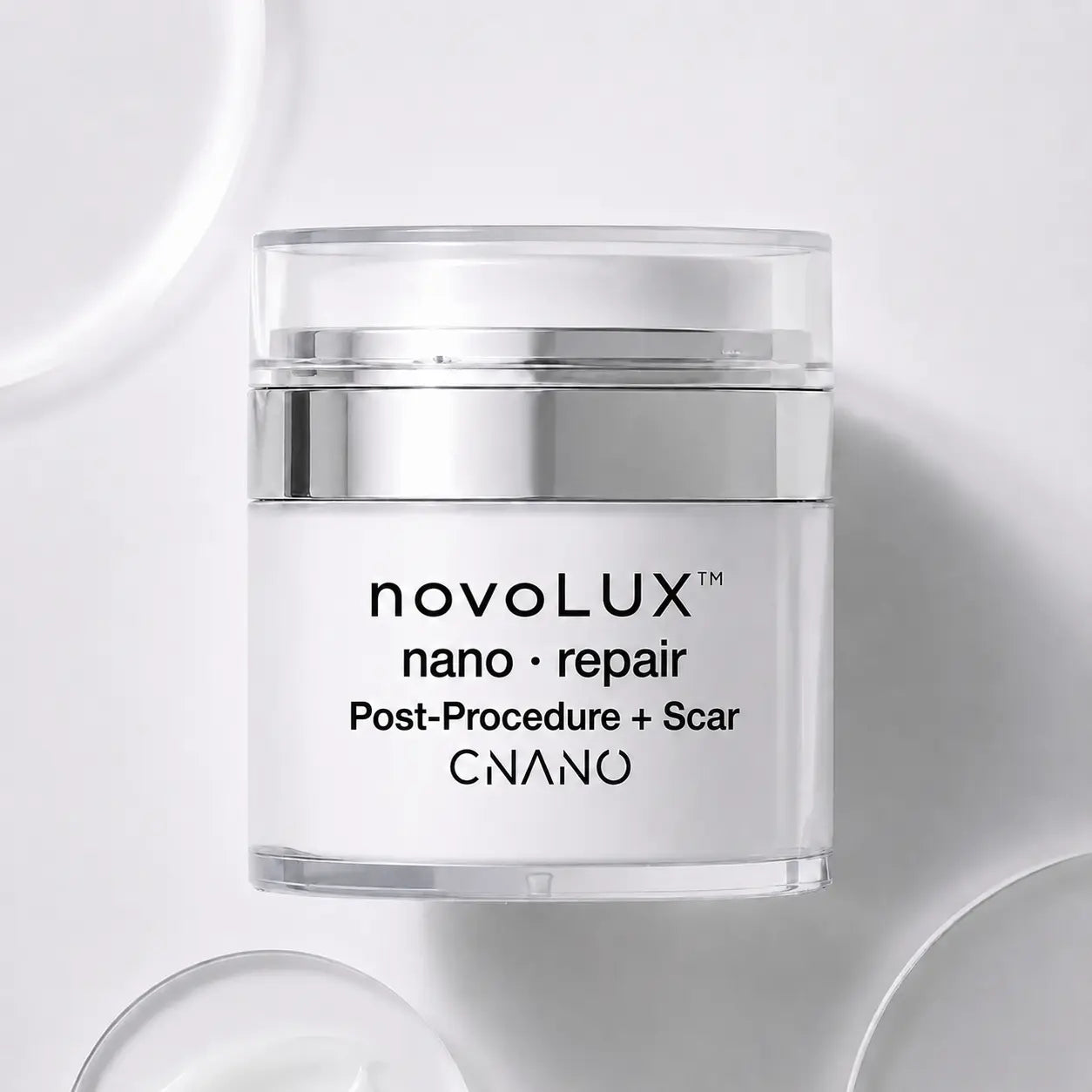 A clear cosmetic jar with a white label reading 'novoLUX nano repair Post-Procedure + Scar CNANO' on a clean white background with soft circular shadows.
