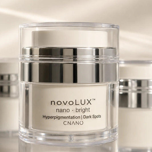 A clear cosmetic jar with a reflective silver metallic band and a white cream product inside, labeled 'novoLUX nano bright Hyperpigmentation | Dark Spots CNANO'.